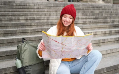 portrait-young-redhead-woman-tourist-sits-with-paper-map-looks-route-tourism-attract